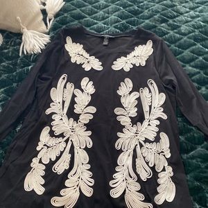 Women’s INC black sheer blouse lined and has pretty bone colored appliqué